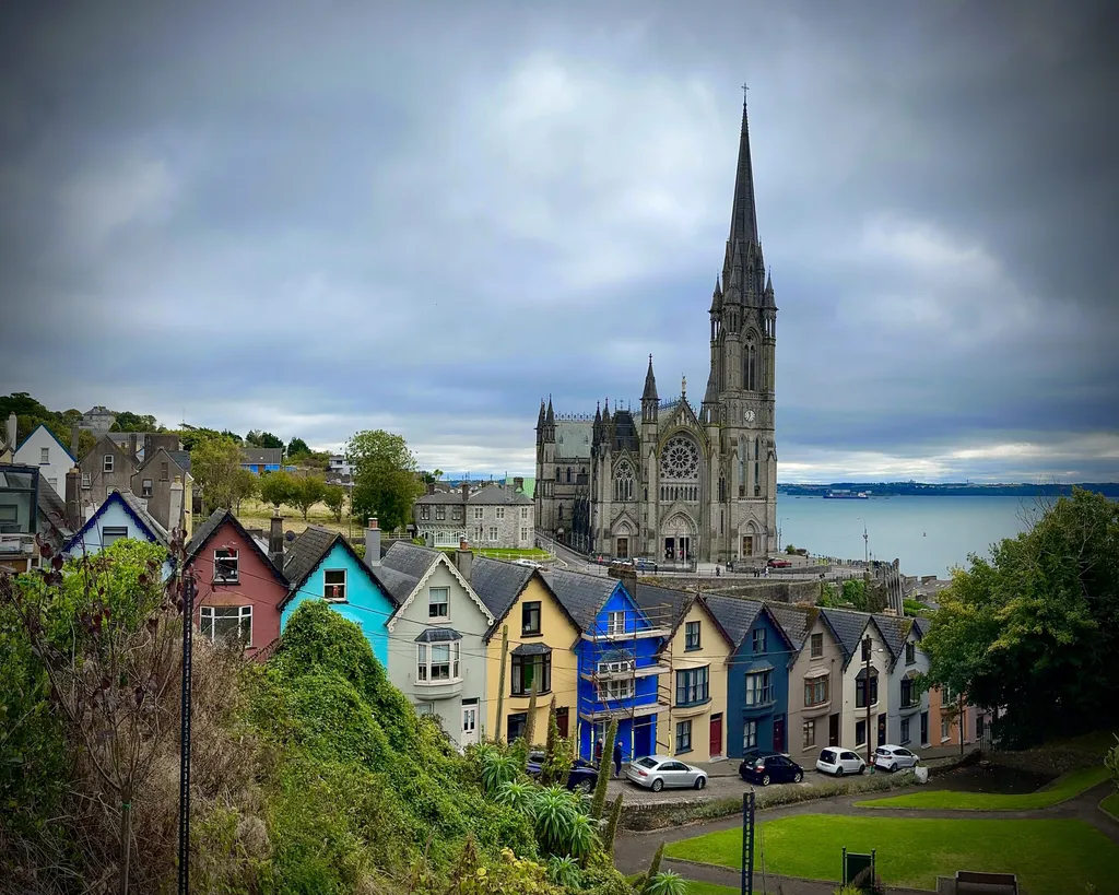 Colorful houses in Cobh with St. Colman's Cathedral